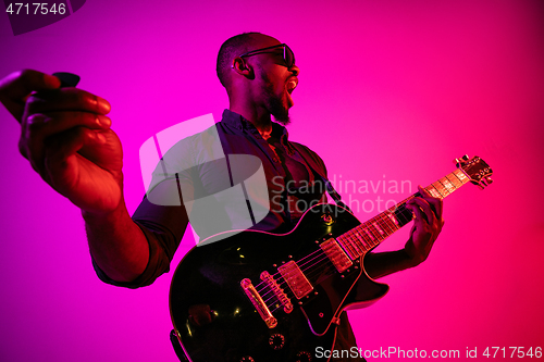 Image of Young african-american jazz musician playing the guitar