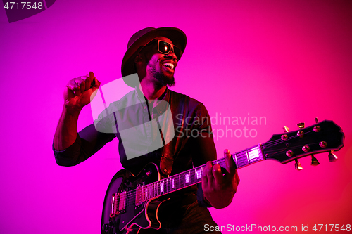 Image of Young african-american jazz musician playing the guitar