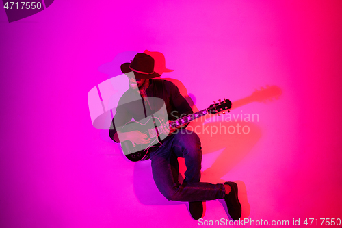 Image of Young african-american jazz musician playing the guitar