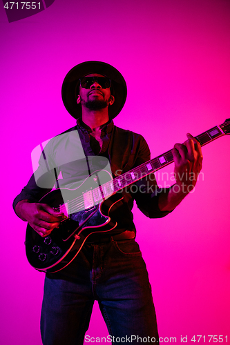 Image of Young african-american jazz musician playing the guitar