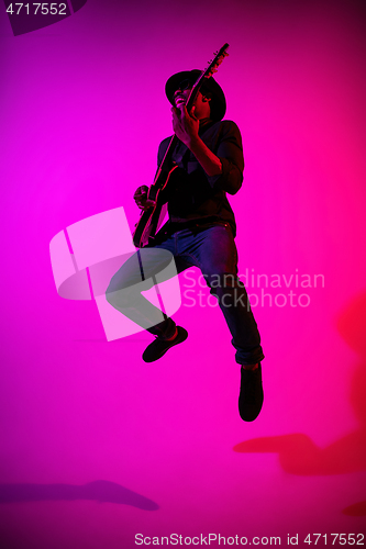 Image of Young african-american jazz musician playing the guitar