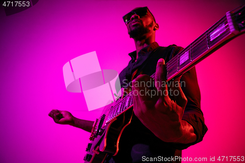 Image of Young african-american jazz musician playing the guitar