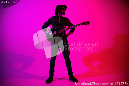 Image of Young african-american jazz musician playing the guitar