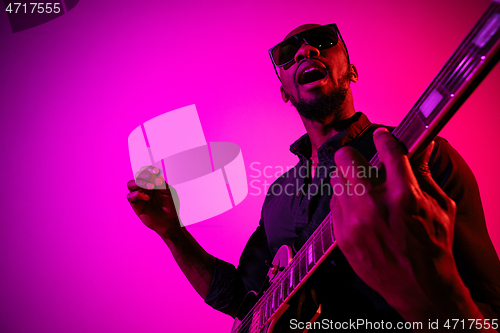 Image of Young african-american jazz musician playing the guitar