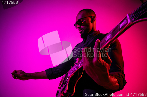 Image of Young african-american jazz musician playing the guitar