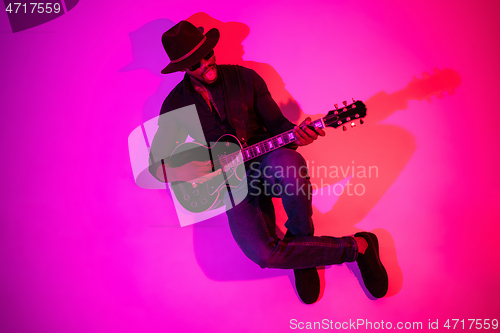 Image of Young african-american jazz musician playing the guitar