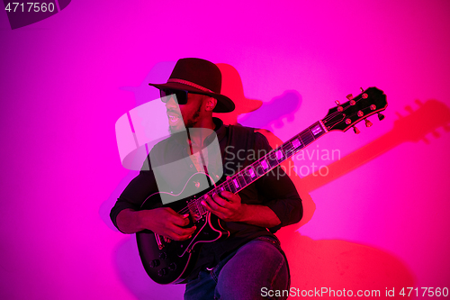 Image of Young african-american jazz musician playing the guitar