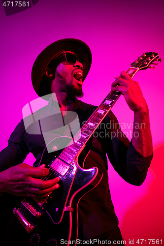 Image of Young african-american jazz musician playing the guitar