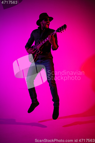 Image of Young african-american jazz musician playing the guitar