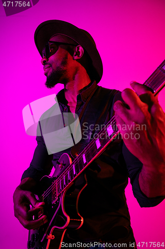 Image of Young african-american jazz musician playing the guitar