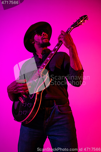 Image of Young african-american jazz musician playing the guitar