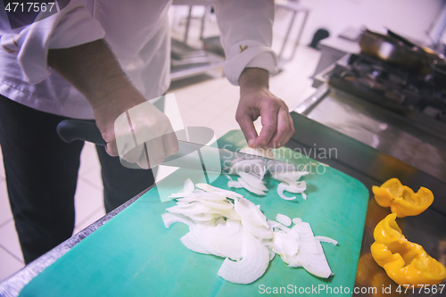 Image of Chef hands cutting fresh and delicious vegetables