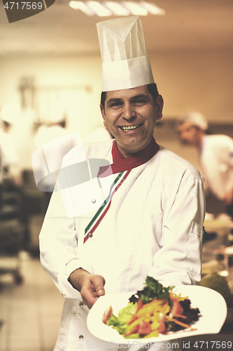 Image of Chef showing a plate of tasty meal