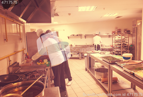 Image of team cooks and chefs preparing meals