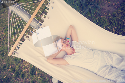 Image of young woman resting on hammock