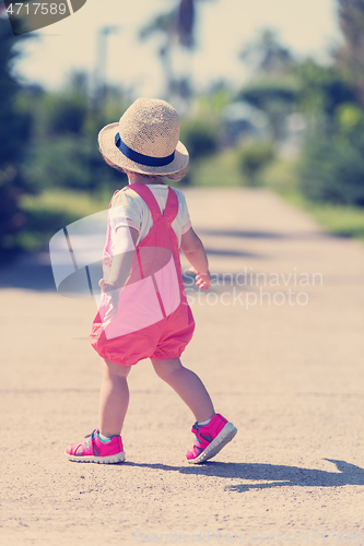 Image of little girl runing in the summer Park