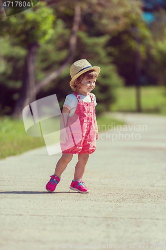 Image of little girl runing in the summer Park