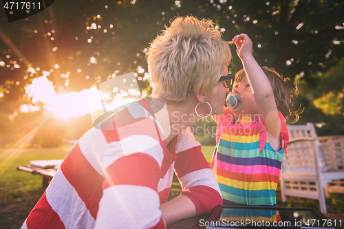 Image of mom and her little daughter using tablet computer