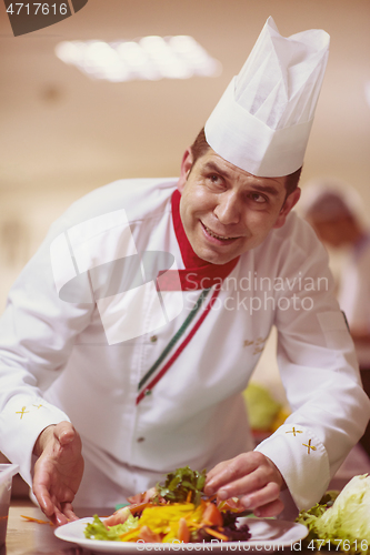 Image of chef serving vegetable salad