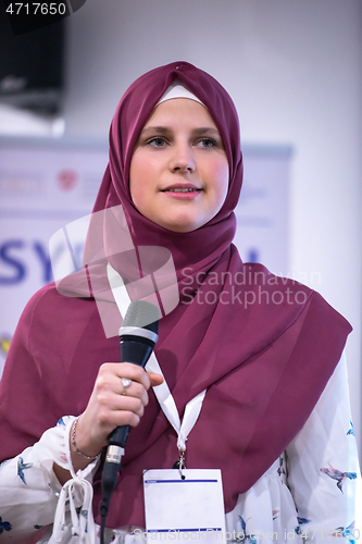 Image of Muslim businesswoman giving presentations at conference room