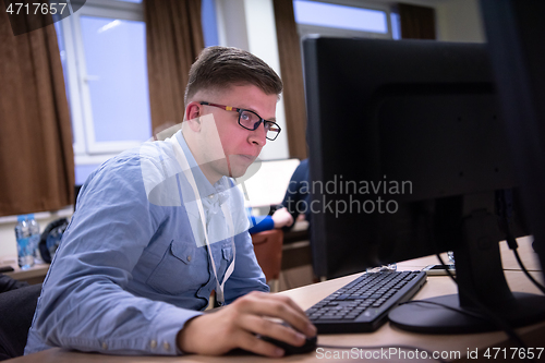 Image of businessman working using a computer in startup office