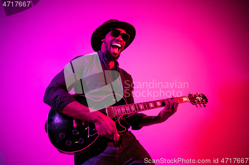 Image of Young african-american jazz musician playing the guitar