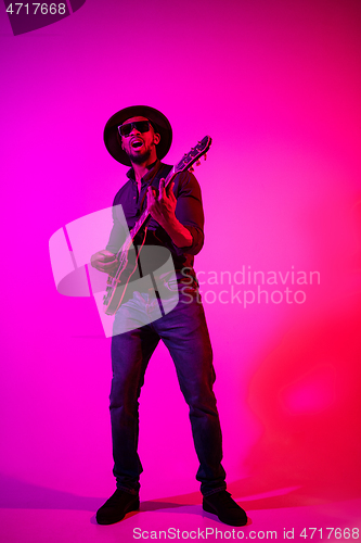 Image of Young african-american jazz musician playing the guitar