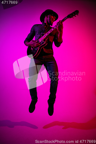 Image of Young african-american jazz musician playing the guitar