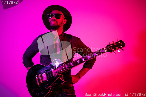 Image of Young african-american jazz musician playing the guitar