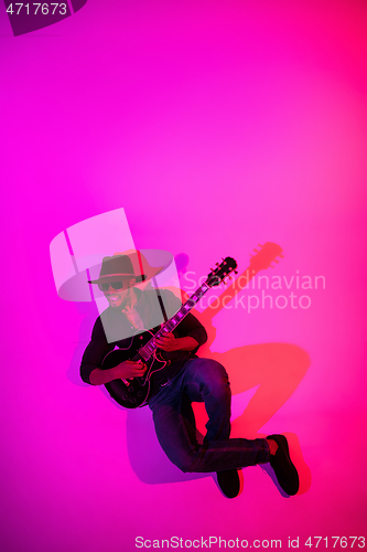 Image of Young african-american jazz musician playing the guitar