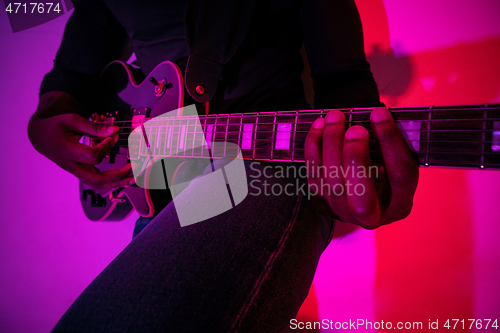 Image of Young african-american jazz musician playing the guitar