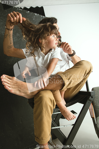 Image of Father playing with young son in their sitting room