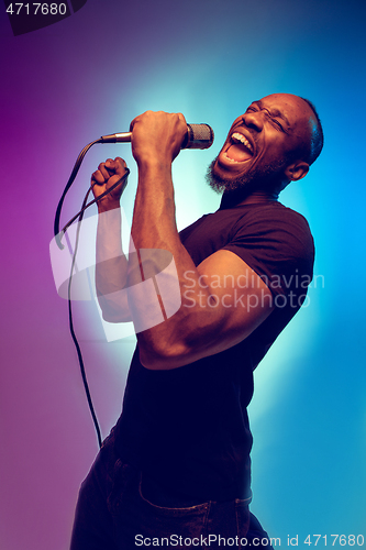 Image of Young african-american jazz musician singing a song