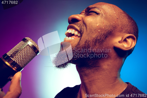 Image of Young african-american jazz musician singing a song