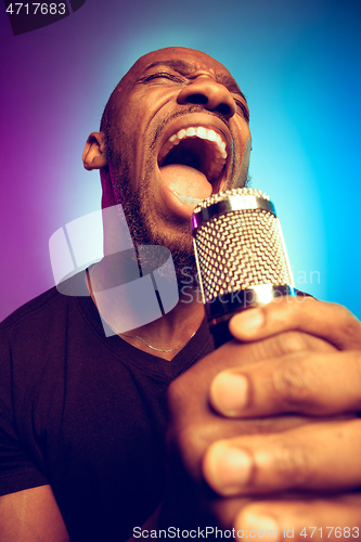 Image of Young african-american jazz musician singing a song