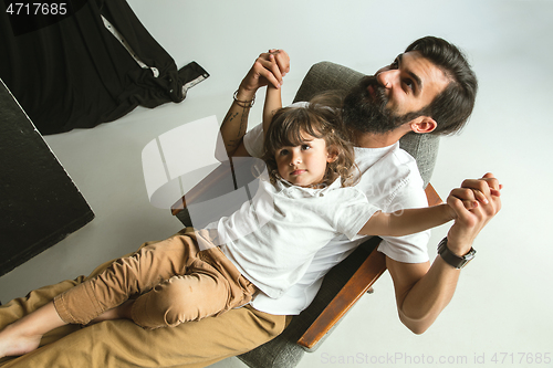 Image of Father playing with young son in their sitting room