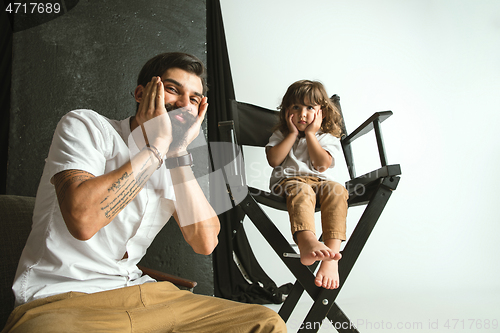 Image of Father playing with young son in their sitting room