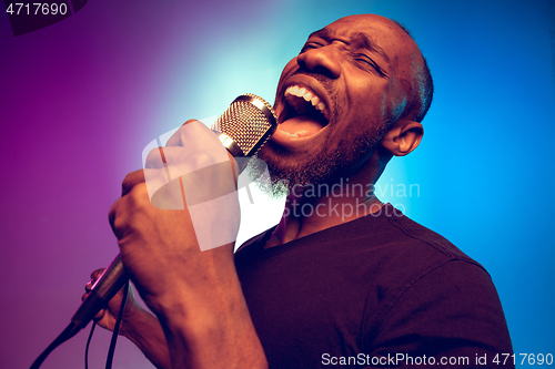 Image of Young african-american jazz musician singing a song