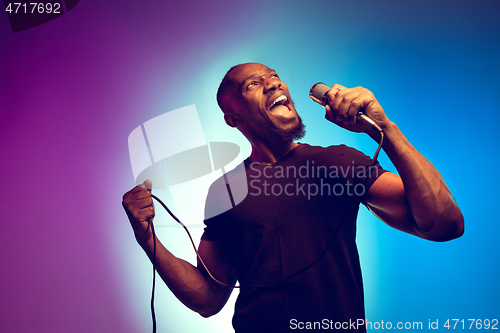 Image of Young african-american jazz musician singing a song