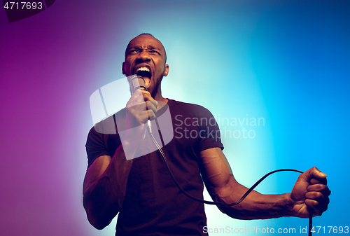 Image of Young african-american jazz musician singing a song