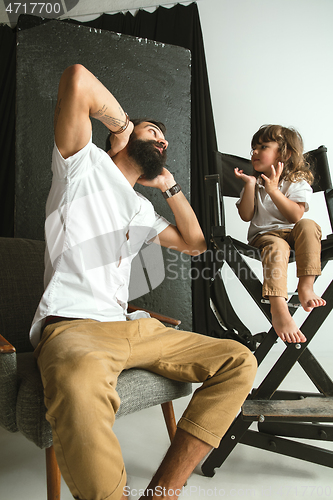 Image of Father playing with young son in their sitting room