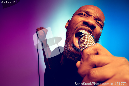 Image of Young african-american jazz musician singing a song