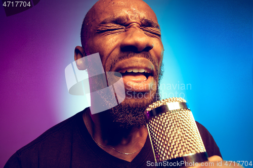 Image of Young african-american jazz musician singing a song