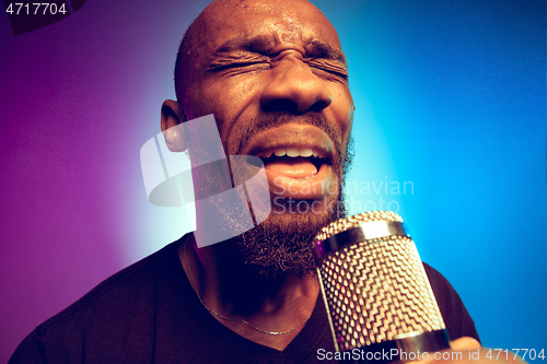 Image of Young african-american jazz musician singing a song