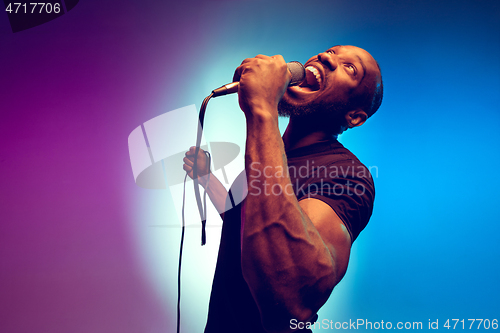 Image of Young african-american jazz musician singing a song