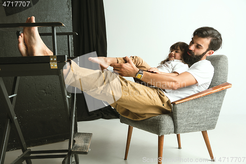 Image of Father playing with young son in their sitting room