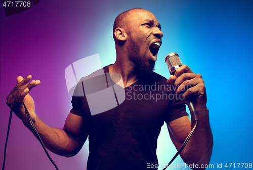 Image of Young african-american jazz musician singing a song