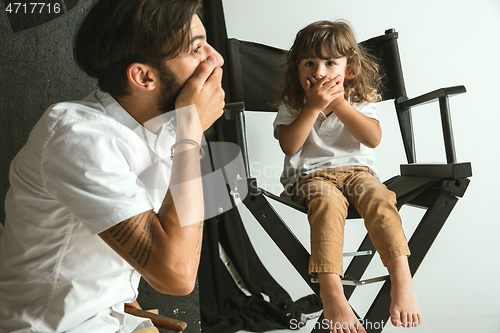 Image of Father playing with young son in their sitting room