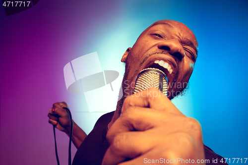 Image of Young african-american jazz musician singing a song