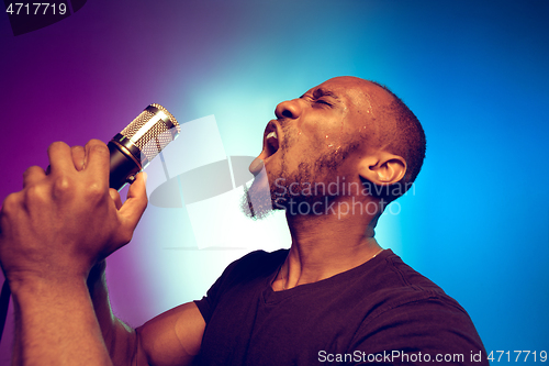 Image of Young african-american jazz musician singing a song
